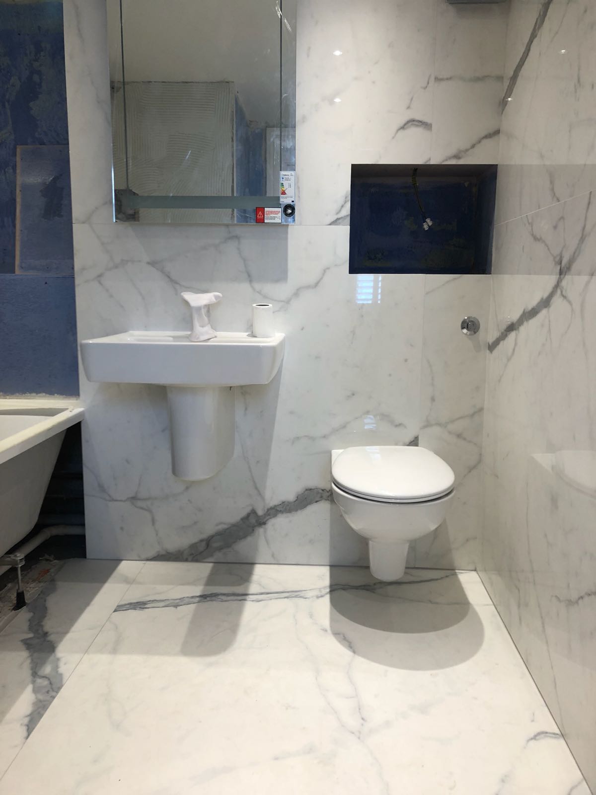 Bathroom refurbishment with wall-mounted fittings